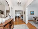 Entry Hallway with wood floors leading to open living spaces, enhanced by natural light at 4900 Old Millcrest Ct, Raleigh, NC 27609