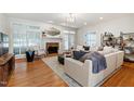 Bright living room with hardwood floors, fireplace, and modern furniture at 4900 Old Millcrest Ct, Raleigh, NC 27609