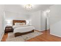 Spacious main bedroom with hardwood floors, natural light, and neutral decor at 4900 Old Millcrest Ct, Raleigh, NC 27609