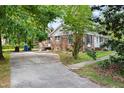 Brick home with a side driveway and a small yard, offering convenient parking at 5802 Newhall Rd, Durham, NC 27713