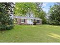 Well-maintained brick home featuring manicured lawn and traditional black shutters at 5802 Newhall Rd, Durham, NC 27713