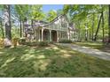 Beautiful home with brick and siding exterior, a covered porch, and a meticulously maintained front yard at 6000 Canadero Dr, Raleigh, NC 27612