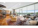 Light filled open concept living room with hardwood floors, area rug, comfortable seating, and large windows overlooking the view at 601 W Rosemary St # 905, Chapel Hill, NC 27516