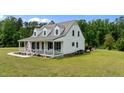 Spacious home with a metal roof, large lawn and a covered front porch at 675 Anderson Creek Rd, Henderson, NC 27537