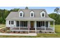 Charming two-story home with a welcoming front porch and American flag at 675 Anderson Creek Rd, Henderson, NC 27537