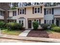 Charming townhome with brown shutters and lovely landscaped yard at 7015 Staghorn Ln, Raleigh, NC 27615