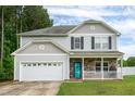 Beautiful two-story home with a covered front porch and attached garage at 71 Hunters Way, Angier, NC 27501