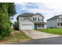 Two-story home with a long driveway leading to an attached two-car garage at 71 Hunters Way, Angier, NC 27501