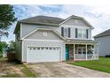 Two-story home with a covered front porch and attached two-car garage at 71 Hunters Way, Angier, NC 27501