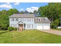 Charming two-story traditional home with two-car garage, well-manicured lawn, and beautiful landscaping at 7209 Halstead Ln, Raleigh, NC 27613