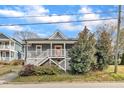 Inviting home with a classic front porch, manicured landscaping, and an appealing exterior design at 725 S State St, Raleigh, NC 27601