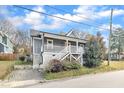 Beautiful home with a welcoming front porch, lovely landscaping, and a convenient driveway for easy access at 725 S State St, Raleigh, NC 27601