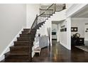 Spacious foyer with dark wood floors, a staircase, and a view into the living area at 7517 Summer Pines Way, Wake Forest, NC 27587
