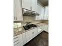Close up of kitchen with stainless range hood and granite counters at 7517 Summer Pines Way, Wake Forest, NC 27587