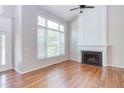 Bright living room featuring a fireplace and large windows with beautiful natural light at 8124 Greywinds Dr, Raleigh, NC 27615