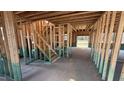 Interior view of the home's framing, showing the staircase and open-concept layout on the main level at 91 Gobbler Dr, Smithfield, NC 27577