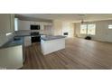 Bright kitchen featuring white cabinets, stainless steel appliances, and a center island at 10 Silver Ct, Smithfield, NC 27577