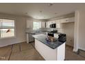 Bright kitchen showcasing white cabinets, stainless steel appliances, and a center island at 10 Silver Ct, Smithfield, NC 27577