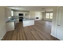 Bright open-concept kitchen featuring white cabinets, modern appliances, new floors, and recessed lighting throughout at 10 Silver Ct, Smithfield, NC 27577