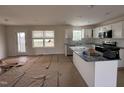 Open kitchen with stainless steel appliances, island, and convenient access to outdoor space at 10 Silver Ct, Smithfield, NC 27577