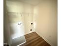 Laundry room includes wood floors, a utility sink, and washer and dryer hookups at 10 Silver Ct, Smithfield, NC 27577