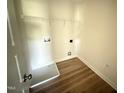 Bright and functional laundry room featuring a wire rack shelf and washer/dryer hookups at 10 Silver Ct, Smithfield, NC 27577