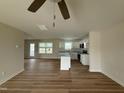 Bright open-concept living room and kitchen with modern wood-look floors and lots of light at 10 Silver Ct, Smithfield, NC 27577