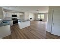 Open-concept living space with kitchen, island, and wood floors, creating an inviting atmosphere at 10 Silver Ct, Smithfield, NC 27577