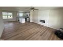 Open-concept living room with wood flooring, a shiplap fireplace accent wall, and an adjacent kitchen at 10 Silver Ct, Smithfield, NC 27577