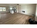 Open-concept living room and kitchen with hardwood floors and fireplace at 10 Silver Ct, Smithfield, NC 27577