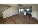 Open-concept living area with wood flooring flowing into the bright kitchen at 10 Silver Ct, Smithfield, NC 27577