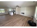 Spacious living room and kitchen area with modern appliances, a kitchen island, and wood flooring at 10 Silver Ct, Smithfield, NC 27577