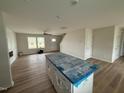 Open-concept living room with hardwood floors, island, and fireplace at 10 Silver Ct, Smithfield, NC 27577
