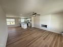 Spacious living room open to the kitchen features a ceiling fan and modern fireplace at 10 Silver Ct, Smithfield, NC 27577