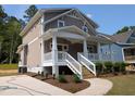 Beautiful exterior featuring a welcoming front porch and well-maintained landscaping at 1005 Forrestal Pl, Durham, NC 27707