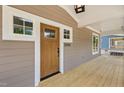 Close-up of the front door, showcasing the wooden door, house number, and covered porch at 1005 Forrestal Pl, Durham, NC 27707