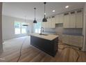 Open kitchen with a center island, modern light fixtures, and stylish cabinetry, perfect for cooking at 1005 Forrestal Pl, Durham, NC 27707