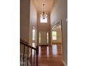 Grand foyer with soaring ceilings, hardwood floors, and views into the formal dining and living rooms at 102 Revere Forest Ct, Cary, NC 27519