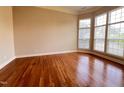 Spacious living room with hardwood floors and large windows letting in natural light at 102 Revere Forest Ct, Cary, NC 27519