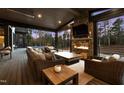 Inviting covered patio features a stone fireplace, comfortable seating, and scenic views of the wooded backyard at 103 Patriot Way, Apex, NC 27523