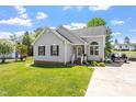 Charming single-story home with gray siding and a well-manicured lawn and driveway at 106 Northwinds Dr, Wendell, NC 27591