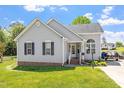 Charming single-story home with gray siding and brick accents on a well-manicured lawn at 106 Northwinds Dr, Wendell, NC 27591