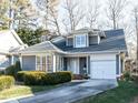 Charming one-story home features a manicured lawn, gray siding, and an attached one car garage at 11 Whitburn Pl, Durham, NC 27705
