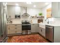 Modern kitchen showcasing stainless steel appliances, white subway tile, and an eye-catching oriental rug at 112 E Edgewood Dr, Durham, NC 27704