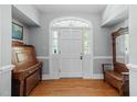 Welcoming foyer with a hardwood floor, arched front door, and classic furnishings at 12200 Glenlivet Way, Raleigh, NC 27613