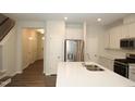 Modern kitchen with stainless steel appliances, center island and sleek design elements at 123 Hunston Dr, Holly Springs, NC 27540
