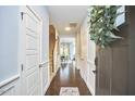 Inviting home hallway with hardwood floors, white trim, and staircase leading to the upper level at 1238 Exchange Pl, Durham, NC 27713