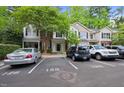 Exterior view of townhomes with designated parking and tree-lined landscaping in a well-maintained community at 126 Star Thistle Ln, Cary, NC 27513