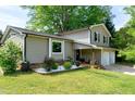 Charming two-story home featuring neutral siding, black shutters, a two-car garage, and manicured landscaping at 1321 Bloomingdale Dr, Cary, NC 27511
