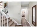 Hallway showcasing hardwood floors, stairway, and access to a room with carpet at 1321 Bloomingdale Dr, Cary, NC 27511